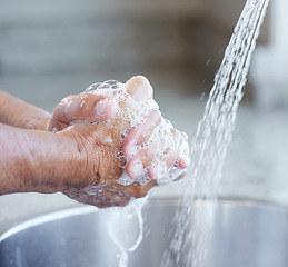 Image showing Hands, washing and soap with water at sink for health, hygiene or self care to stop bacteria, virus or infection. Person, cleaning palm or skincare in home with faucet, wellness or closeup of bubbles