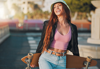 Image showing Summer, happy and skateboard with woman in city for freedom, sports and relax lifestyle. Training, fitness and sunset with girl walking in urban town enjoying adventure, wellness and energy vacation