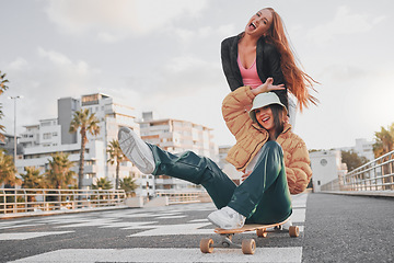 Image showing Fun, comic and portrait of friends on a skateboard for the weekend, bonding and playing in the city. Energy, smile and crazy women skateboarding for funny activity, happiness and playful in Sweden