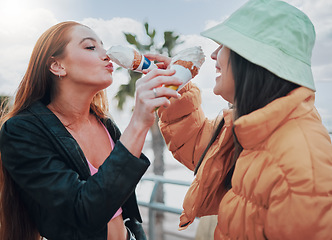 Image showing Ice cream, comic and friends in the city for bonding, weekend and quality time in Portugal. Silly, summer and funny women feeding and eating a sweet dessert together for break, friendship and holiday