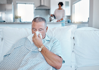 Image showing Allergies, sick and senior man on sofa cleaning his nose for retirement, pension or elderly healthcare home. Virus, bacteria or allergy of old person on couch in house and woman in kitchen for help