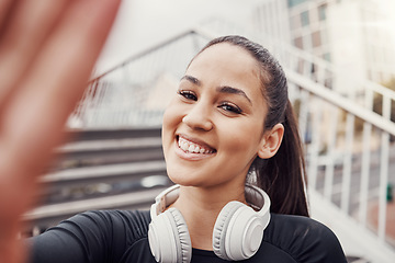 Image showing Woman, face and selfie with headphones and fitness in city, happy in Brazil, smile in portrait and exercise outdoor. Runner, cardio and happiness in picture, health and wellness with active lifestyle