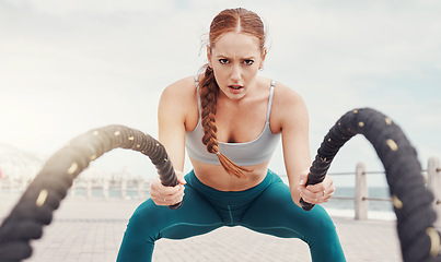 Image showing Woman, battle rope exercise and portrait at ocean park for fitness, strong body and wellness at outdoor training. Girl, focus and workout by sea with goal, target or motivation for muscle development