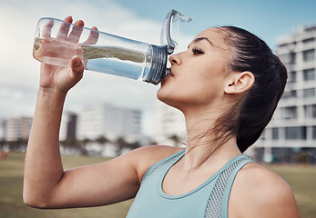 Image showing Fitness, woman and drinking water in the city after running, exercise or cardio workout in Cape Town. Female runner with bottle and natural drink for thirst, hydration or aqua liquid for sports break