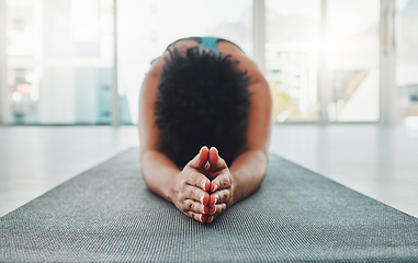 Image showing Yoga, arm stretching and prayer hands of a black woman in a gym for zen, relax and exercise. Pilates, peace and meditation training of an athlete in prayer pose on the floor feeling calm from stretch