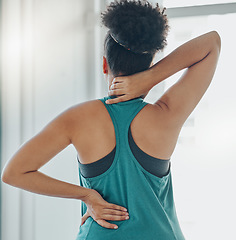 Image showing Black woman, neck and back pain at exercise, training or workout for physical development in home. Girl, muscle stress and burnout at gym for fitness, wellness and performance with injury in gym