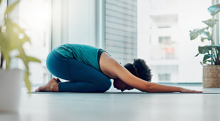 Image showing Yoga, child pose and wellness exercise of a black woman in a gym or health studio for pilates. Meditation, peace and relax female person doing a balance, zen and chakra workout for self care