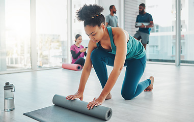 Image showing Yoga, studio and exercise mat with a fitness black woman getting ready for a wellness workout. Gym, training and zen with a female yogi indoor for mental health, balance or spiritual health