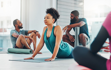 Image showing Yoga class, people and fitness exercise for health, peace and wellness at a gym. Black woman and men group in health studio for holistic workout, cobra and body balance with zen energy or mindfulness