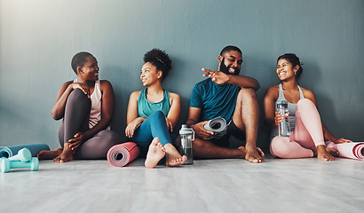 Image showing Yoga, fitness group and diversity of pilates class in a gym with a exercise and training break. Talking, wellness people and communication of friends on a floor ready for zen, balance and relax