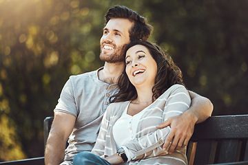 Image showing Love, couple and relax on park bench, laughing and having fun together outdoors. Valentines day, romance hug and care of man and woman sitting on romantic date, laugh at funny joke or comic comedy.