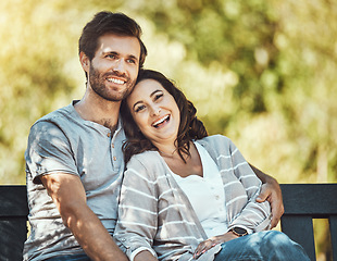 Image showing Couple, love and hug on park bench, laughing at funny joke or comic comedy and having fun together outdoors. Valentines day, romance relax and portrait of man and woman hugging on romantic date.