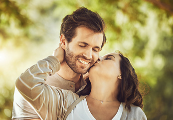 Image showing Kiss, love and couple at park, smile and having fun time together outdoors. Valentines day, romance and care, affection and intimacy of happy man and woman kissing cheek on romantic date outside.