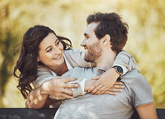 Image showing Hug, love and couple on park bench, smile and having fun time together outdoors. Valentines day, romance relax and care of happy man and woman hugging, embrace and cuddle on romantic date outside.