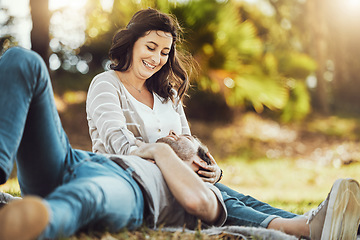 Image showing Love, relax and couple at park, laughing at funny joke or comic comedy and having fun together outdoors. Valentines day, romance cuddle and care of man lying on lap of happy woman on romantic date.