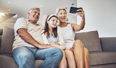 Image showing Selfie, love or happy grandparents with girl in living room bonding as a family in Australia taking pictures. Smile, senior or elderly man relaxing with old woman or child at home together on holiday