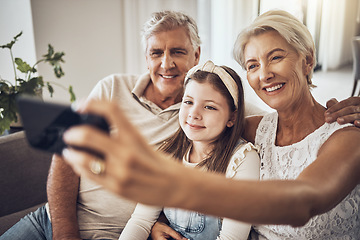 Image showing Selfie, smile or happy grandparents with girl in living room bonding as a family in Australia with love. Pictures, senior or elderly man relaxing with old woman or child at home together on holiday