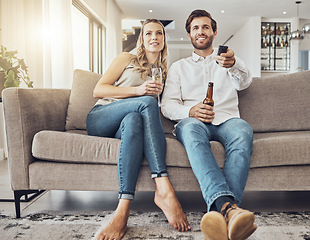 Image showing Tv, couple and relax on sofa with alcohol streaming movie, film or video on valentines day. Champagne, beer or happy man and woman watching movies, online show or television and enjoying time in home