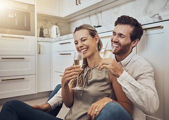 Image showing Laughing, love and couple with champagne in the kitchen for celebration, anniversary and valentines day. Comic, relax and funny man and woman drinking alcohol on the floor with happy conversation