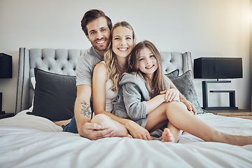 Image showing Love, relax and portrait of a family on a bed embracing, bonding and resting together at their home. Happiness, mother and father sitting and relaxing with their girl child in their bedroom in house.