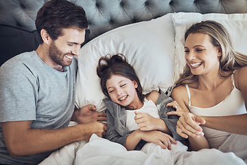 Image showing Family, happy and parents with child relax in bed, weekend or holiday break with love and bonding at home. Fun, happiness and love with care, man and woman with girl, joy and laugh together