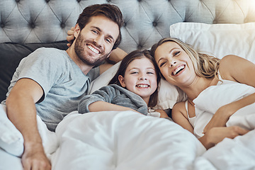 Image showing Love, family and portrait in home bedroom, laughing at funny joke and bonding together. Care, comic and happy man, woman and girl, child or kid in bed, having fun and enjoying quality time in house.