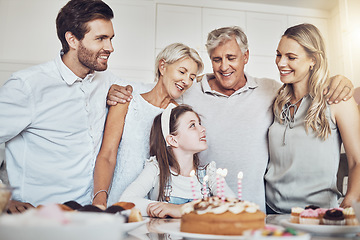 Image showing Birthday party, cake and big family with girl in celebration of special event in house. Love, food and kid with happy father, mother and grandparents celebrating, talking and bonding in home kitchen.