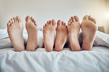 Image showing Family feet, bed and together with kid, parents and sleeping on holiday for bonding, care and happiness. Bedroom, people and sleep with mom, dad and child on vacation to relax, break and hospitality