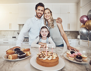 Image showing Birthday party, cake and family portrait in kitchen for celebration event in house. Love, food and kid, girl or child with happy father and mother celebrating special day, care and bonding in home.