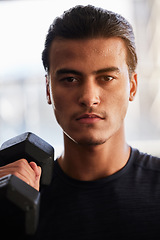 Image showing Fitness, portrait or man with a dumbbell at gym training, exercise or workout for body goals or wellness. Motivation, sports or healthy athlete weightlifting for muscle growth isolated in studio