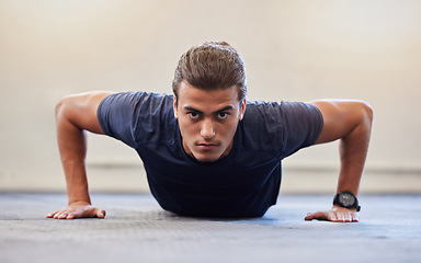 Image showing Fitness, portrait or push up with man in gym training or exercising in a body workout for endurance. Healthy male, strong or powerful sports athlete focused on floor exercise challenge for wellness