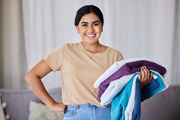 Image showing Portrait, woman and laundry with hygiene, spring cleaning service and chores with smile in home. Maid, Indian female cleaner and happy lady with washed clothes, fabric and housekeeper in living room