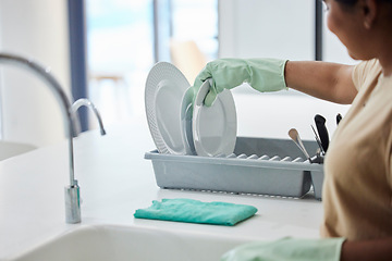 Image showing Woman, hand and dishes in kitchen by sink for washing, packing or hygiene in house with gloves. Cleaner lady, hands or home for dry plate, stop bacteria or cleaning service for health in apartment