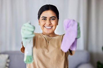 Image showing Woman, portrait and cleaning with product, cloth and smile in home living room for wellness, hygiene or stop bacteria. Happy cleaner, bottle and spray for clean, safe or dirt free house for happiness