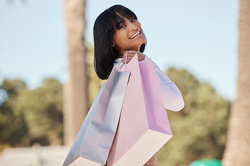 Image showing Happy woman, shopping and portrait in city with happiness of product sales in Brazil. Rich customer, girl and retail gift bags on holiday travel for discount promotion, luxury brand and urban freedom