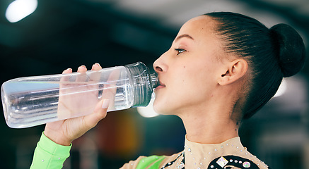 Image showing Woman drinking water, bottle and gymnast in gym, competition with athlete, hydration and health with fitness. Exercise, face profile and active with gymnastics, wellness and healthy with sports