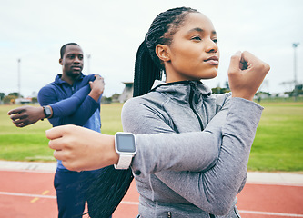 Image showing Fitness, black couple and stretching arms for exercise, health and wellness at stadium. Winter sports, training or man and woman prepare and get ready to start workout, running or exercising outdoors