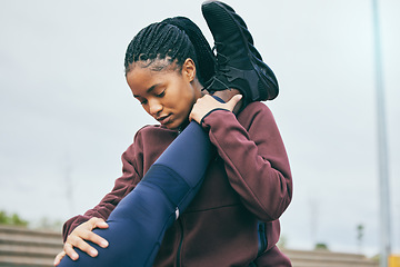 Image showing Fitness, black woman and coach stretching legs for running exercise, workout or preparation at stadium. African American female mentor helping partner in warm up leg stretch for cardio or athletics