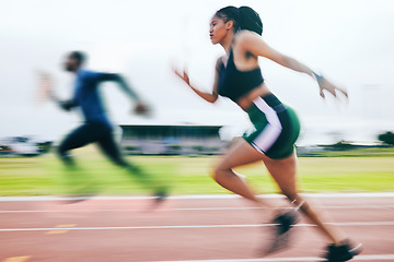 Image showing Black woman, running and athletics in sports race for training, cross fit or exercise in blur on stadium track. African American female runner athlete in fitness, sport or speed run for competition