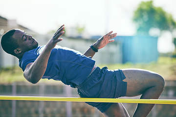 Image showing Man, high jump and fitness or athletics at a stadium for training, energy and cardio against sky background. Jumping, athlete and male outdoors for performance, endurance and competition on mock up