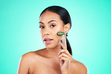 Image showing Portrait, beauty and face massage with roller by woman in studio for wellness, grooming or cosmetic skincare. Facial and jade tool by girl model relax with skin product and isolated on background