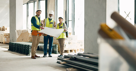 Image showing Building, construction and architect with a team working on site while reading a blueprint or plans indoors. Teamwork, engineer and architecture with a man and woman contractor group in collaboration