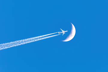 Image showing Passenger plane passes near the moon