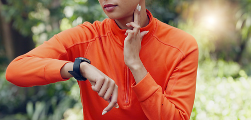 Image showing Fitness, wellness and sport woman heart rate with smartwatch while training, exercise and workout in park and nature. Health, runner and healthy sports girl with watch for time to monitor performance
