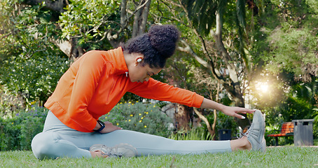 Image showing Black woman stretching leg in the park for fitness, health and wellness before a run. Exercise, sports and female athlete warm up training outside or in nature for mobility, flexibility and strength.