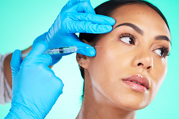 Image showing Skincare, black woman and injection for cosmetics, treatment and girl on blue studio background. Plastic surgery, African American female or confident lady with needle for soft, gloves or smooth skin