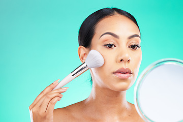 Image showing Beauty, mirror and woman with makeup brush in studio for skincare, grooming and cosmetics on green background, Face, skin and girl relax with facial tool, glamour and product while isolated on mockup