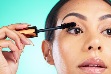 Image showing Woman, face closeup and beauty with mascara for lashes, makeup tools and cosmetic product with microblading Cosmetics, skin and brush in hand for eyelash extension, self care on studio background