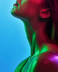 Image showing Woman neck, skincare or neon lighting on isolated blue background in trendy, cool or stylish fantasy art in studio. Zoom, beauty or model body glow in creative aesthetic, green or pink lights texture