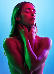 Image showing Glowing skincare, hands or touch in neon lighting on isolated blue background with neck, body or skin. Beauty, model or fashion woman in creative fantasy green, pink or lights aesthetic in cosmetics